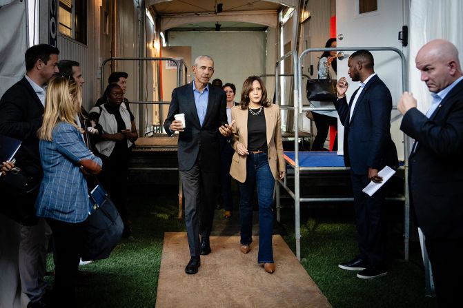 Harris and former President Barack Obama walk and talk backstage before speaking at a campaign rally in Clarkston, Georgia, in October 2024.