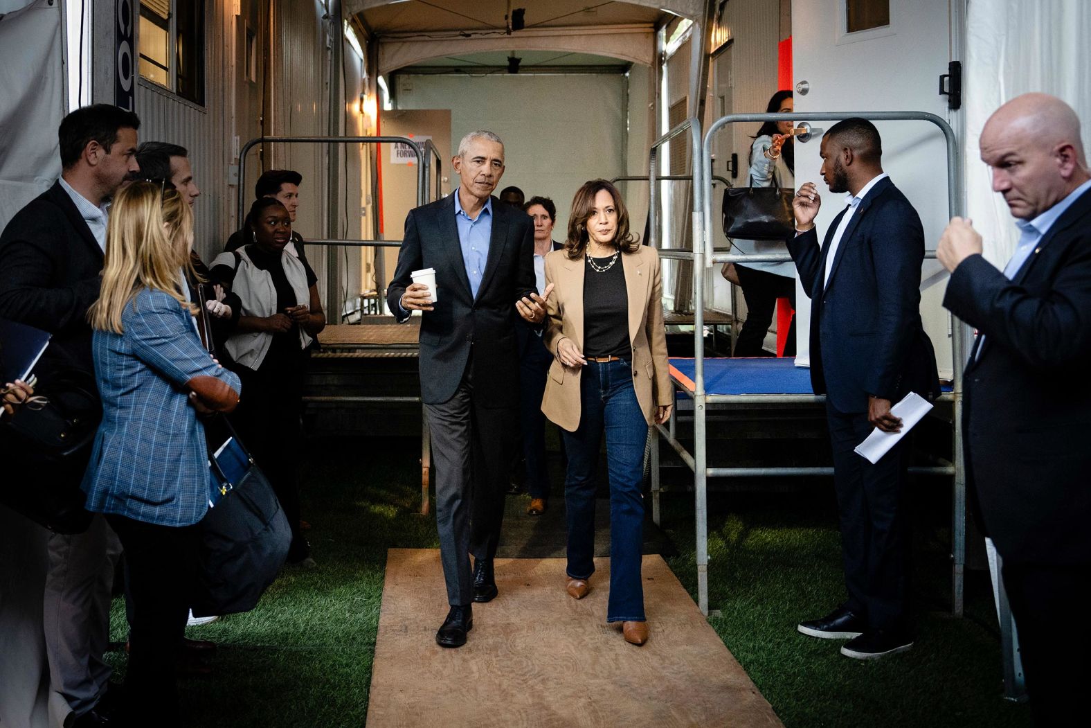 Harris and former President Barack Obama walk and talk backstage before speaking at a campaign rally in Clarkston, Georgia, in October 2024.