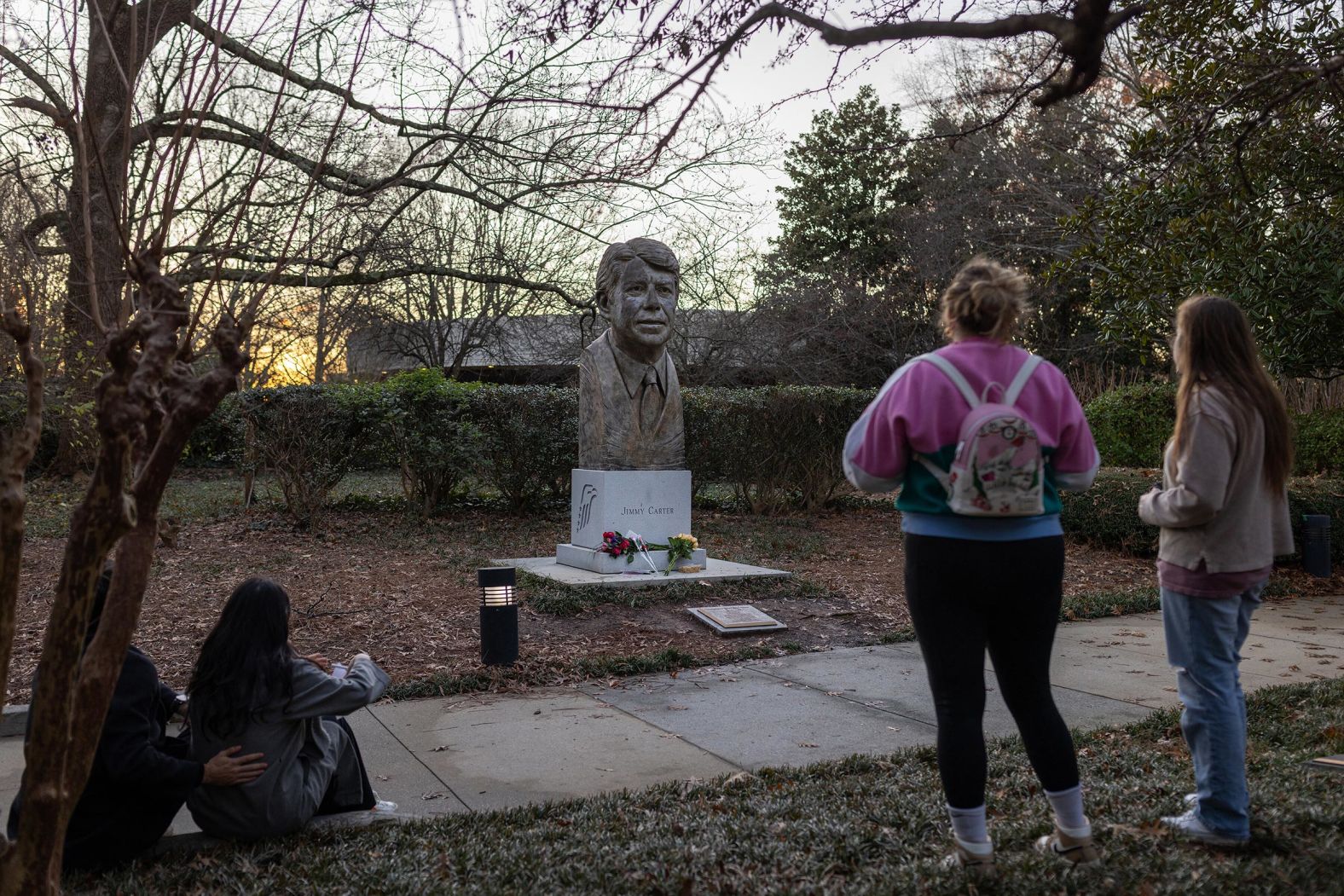 Mourners visit a Carter bust at the Carter Center in Atlanta after his death was announced on December 29.