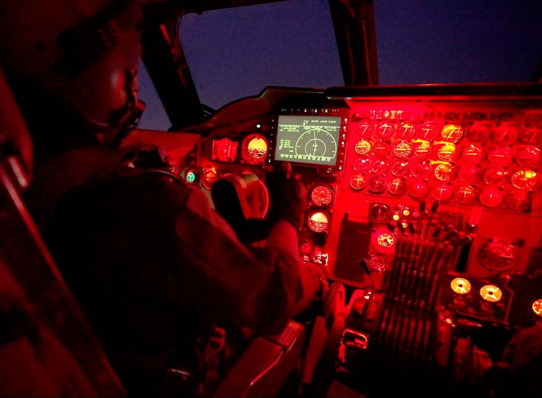 Capt. Sabin “Jett” Park pilots the B-52 at night, using red cockpit lighting to protect his vision in the dark. The main display is one of the few modern additions to the cockpit.