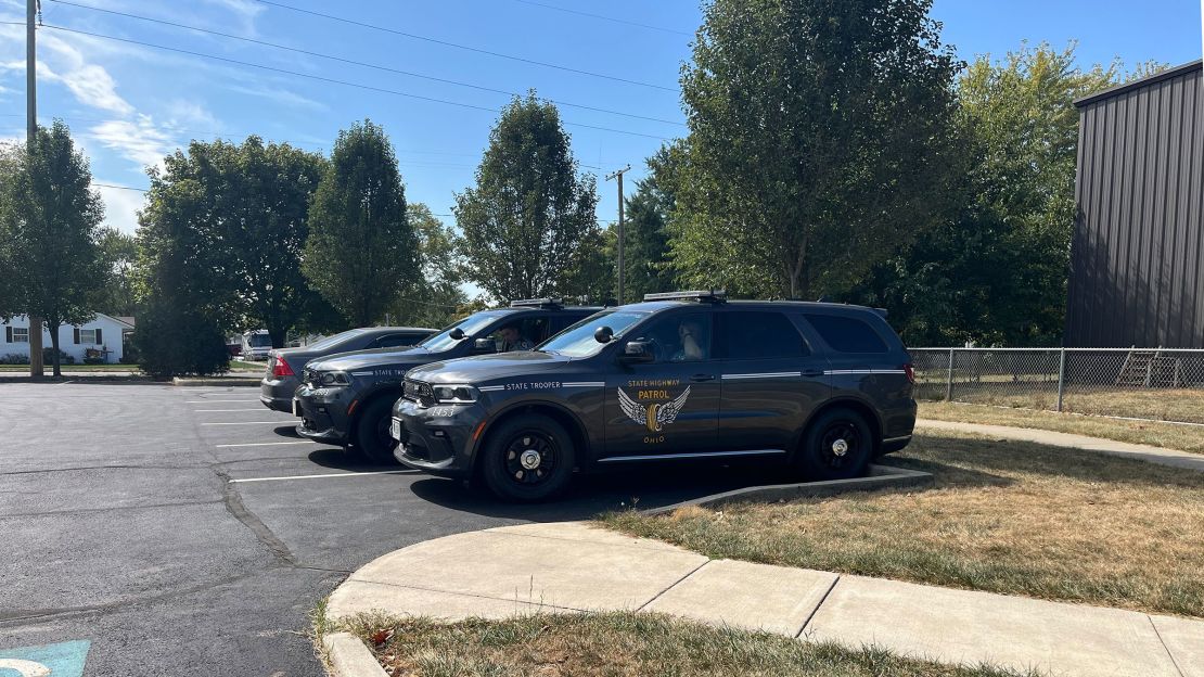 Two Ohio state trooper vehicles were parked outside the Springfield City Schools office Friday. A staffer told CNN having the troopers stand guard was abnormal. 