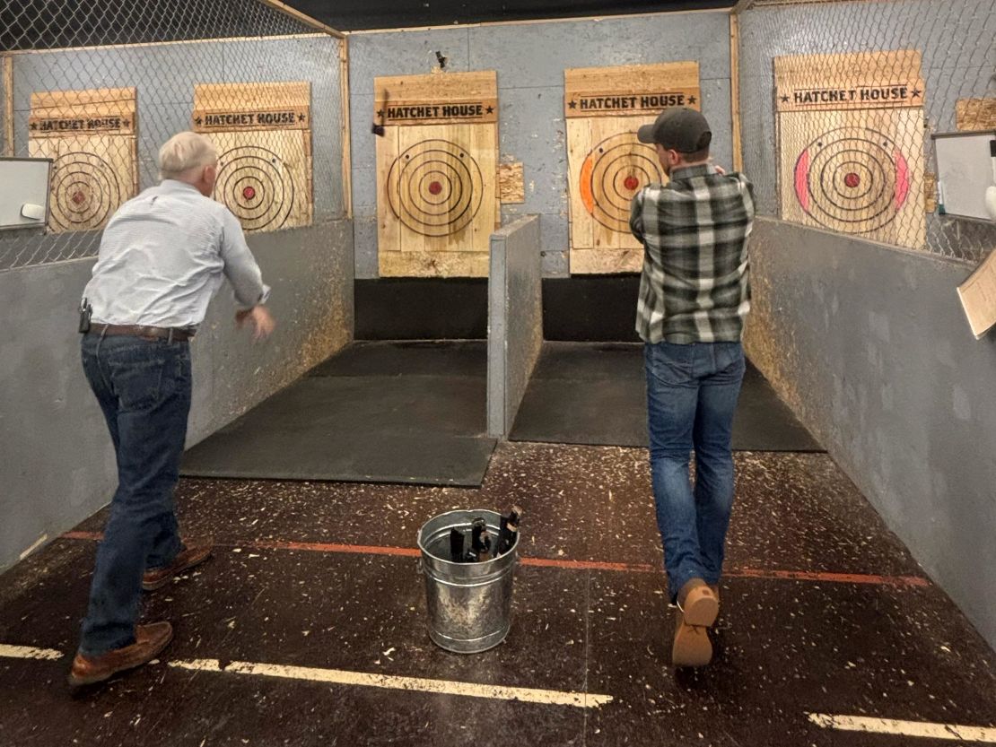 Hatchet House owner Austin Jenkins shows John King how to throw an axe in Greeley, Colorado.