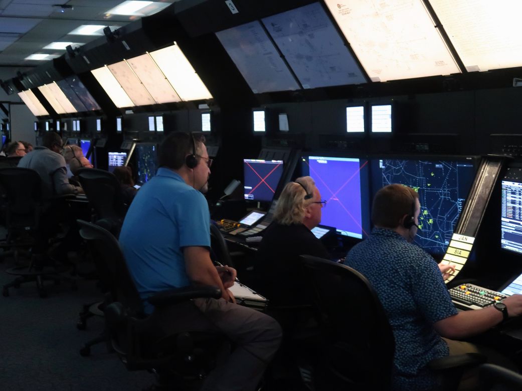 Instructors watch over students learning to operate in a simulated radar control room at the FAA Academy in Oklahoma City.