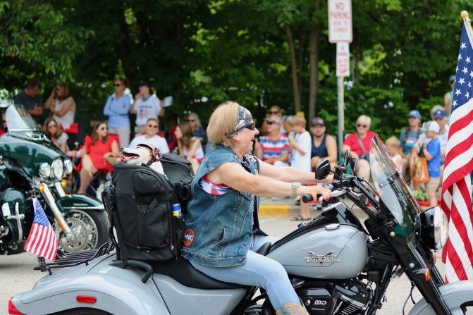 A woman rides a motorcycle during the Fourth of July parade in Cedarburg.