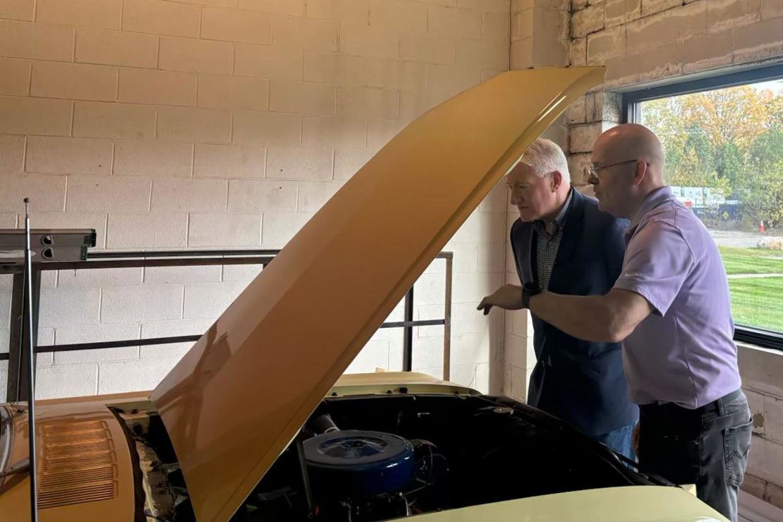 C02 Auto Renewal owner Bill Govier shows John King a car in his workshop in Wixom, MI.