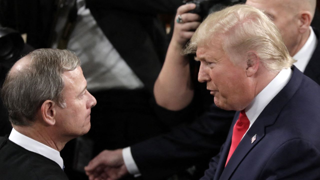 President Donald Trump, right, shakes hands with Chief Justice John Roberts as he arrives to deliver his State of the Union address on Capitol Hill i in Washington on February 4, 2020. 