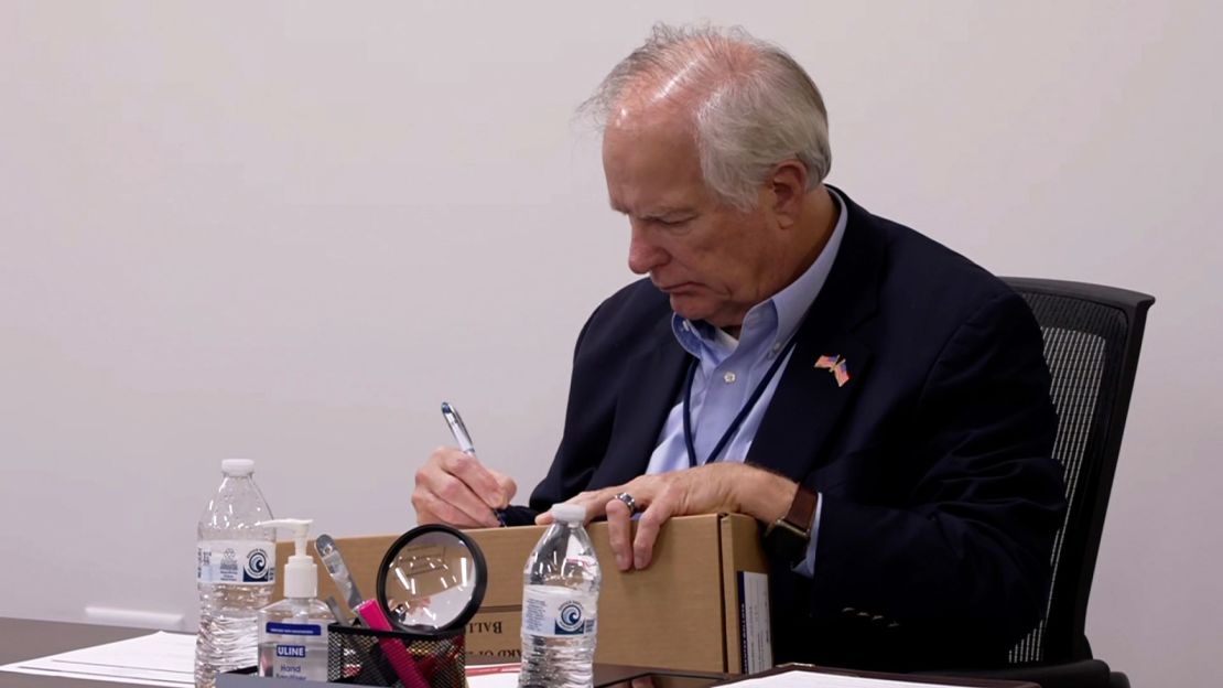 Wake County Board of Elections member Keith Weatherly signs a box of mail-in ballots at the Wake County Board of Elections ballot processing center in Raleigh, North Carolina.