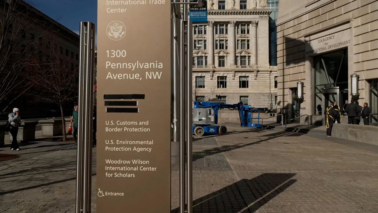 This still from video taken February 7 shows the signage at US Agency for International Development being taped over.