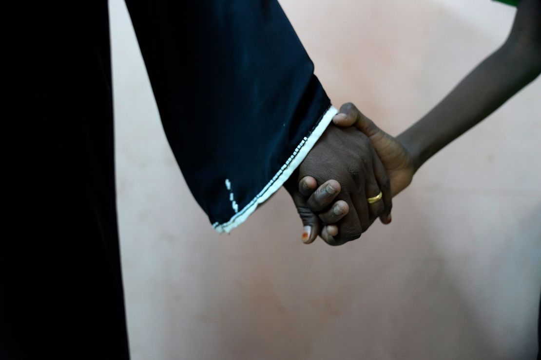 11-year-old Musa, whose name has been changed by UNICEF to protect his identity, holds his mother’s hand tightly after visiting the psychologist and social worker helping him deal with the trauma of rape.