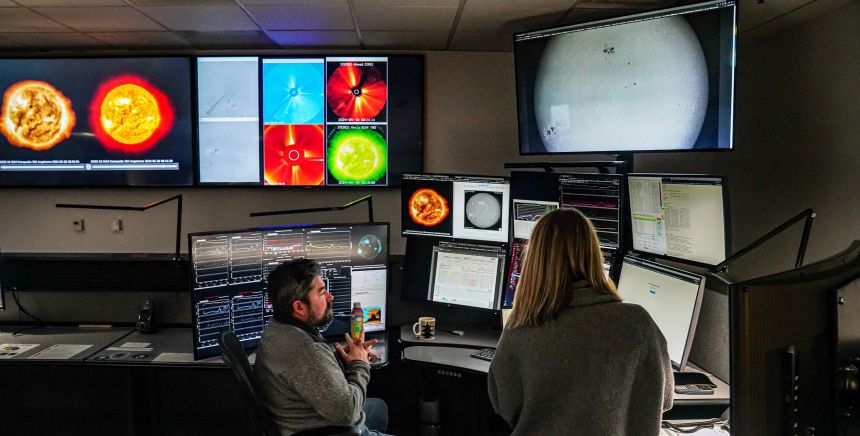Forecasters monitor satellite feeds and other data at the federal Space Weather Prediction Center in Boulder, Colorado, in May 2024.