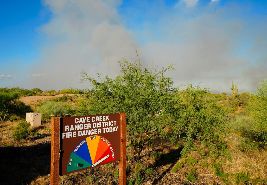 Extreme fire danger signs are placed in front of the Boulder View Fire in North Scottsdale, Arizona, on Friday, June 28.