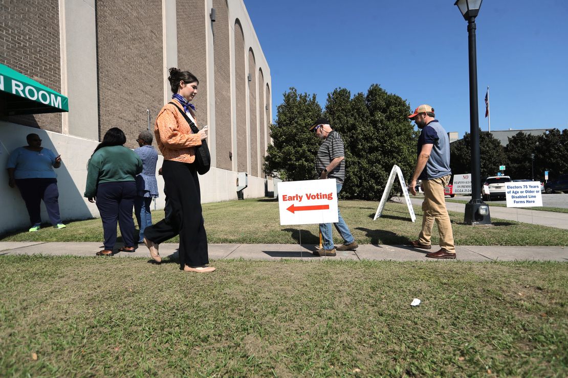 Voters enter and exit the polling location at the Savannh Civic Center on Tuesday, October 15 during the first day of early voting in Georgia.