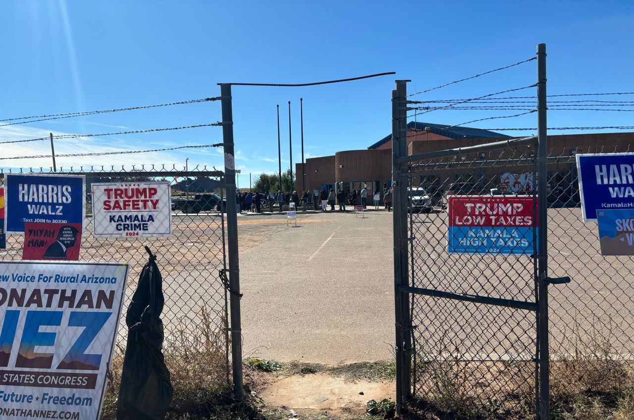 Navajo voters wait to vote outside of the Fort Defiance Chapter House in Apache County where voting issues persist on November 5.