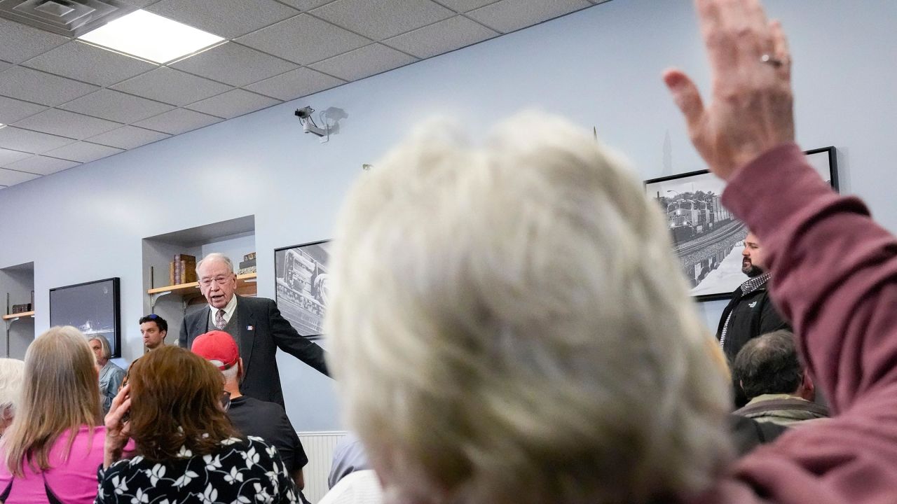 A constituent raises her hand to ask Sen. Chuck Grassley a question during a town hall April 15 in Fort Madison, Iowa.