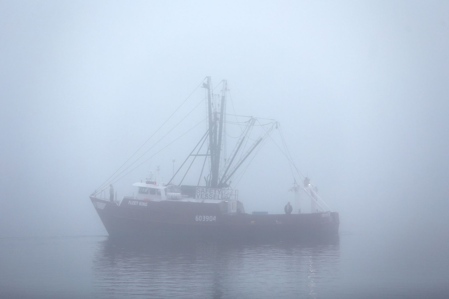 A fishing boat heads out to sea from Fairhaven, Massachusetts, on a foggy morning Friday, November 14.