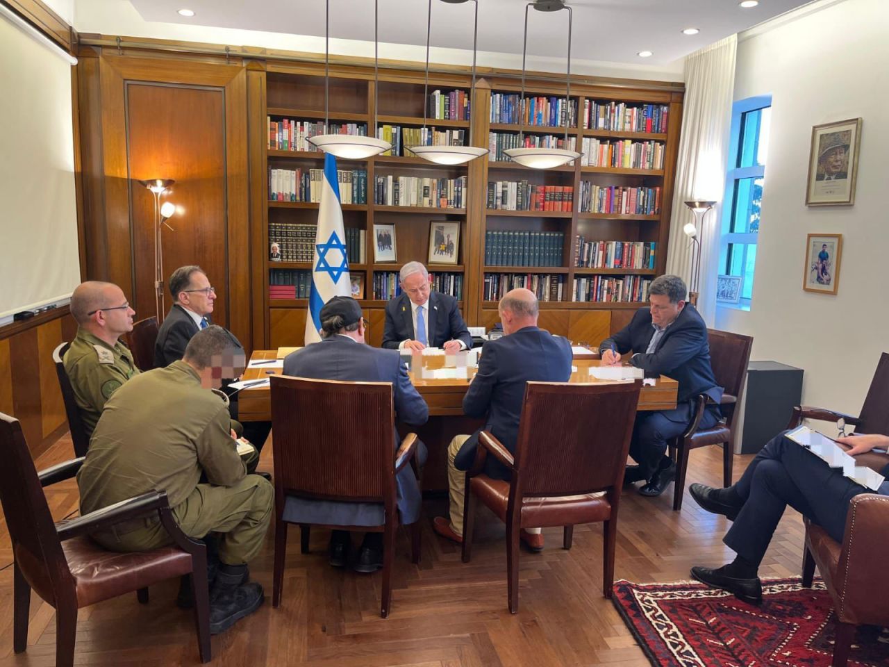 In this handout photo from the Israeli Prime Minister's Office, Prime Minister Benjamin Netanyahu and his advisers hold a phone call with US President Joe Biden on October 9.