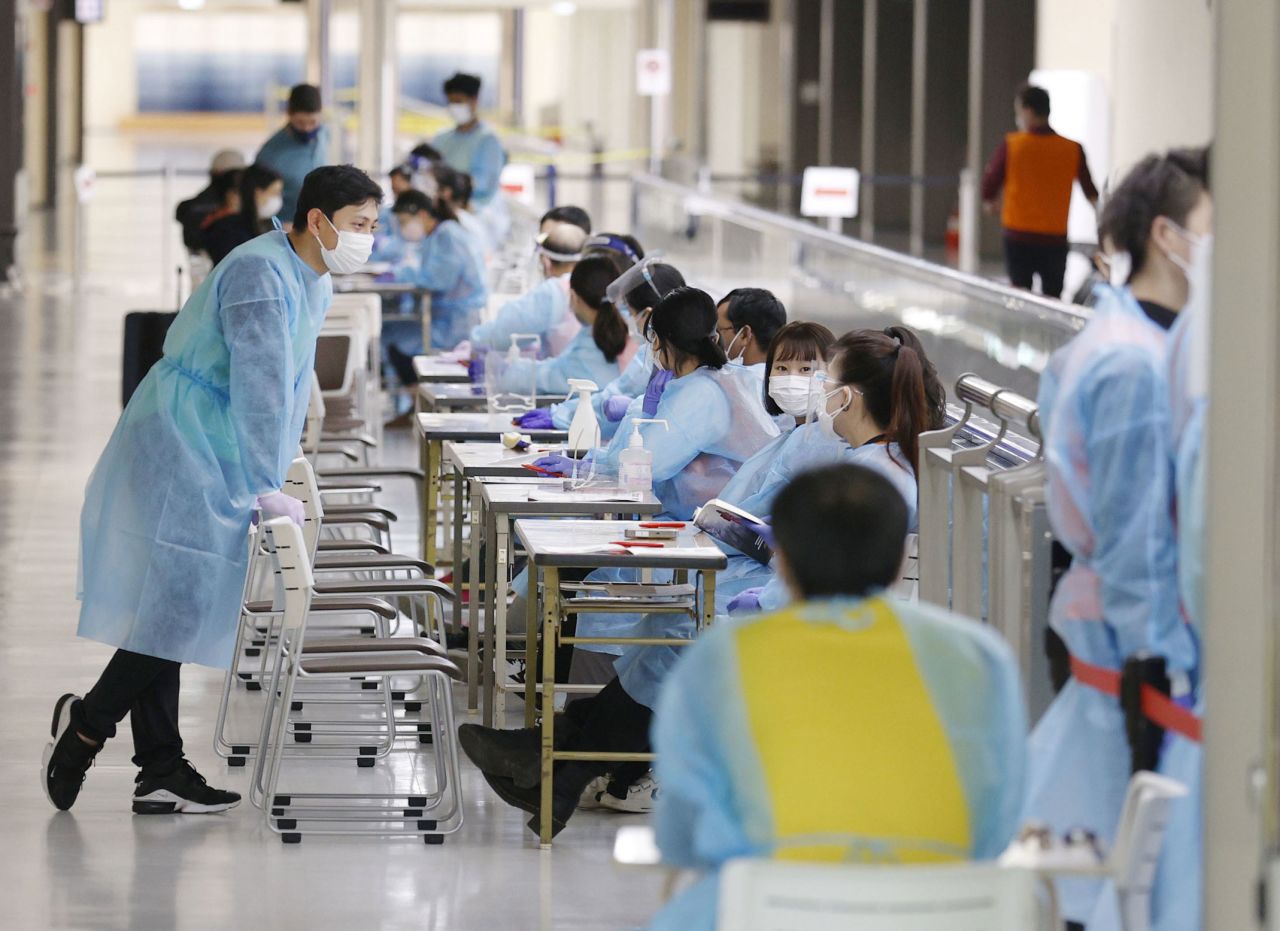 Photo taken on Nov. 29, 2021, shows quarantine staff working at Narita airport near Tokyo.