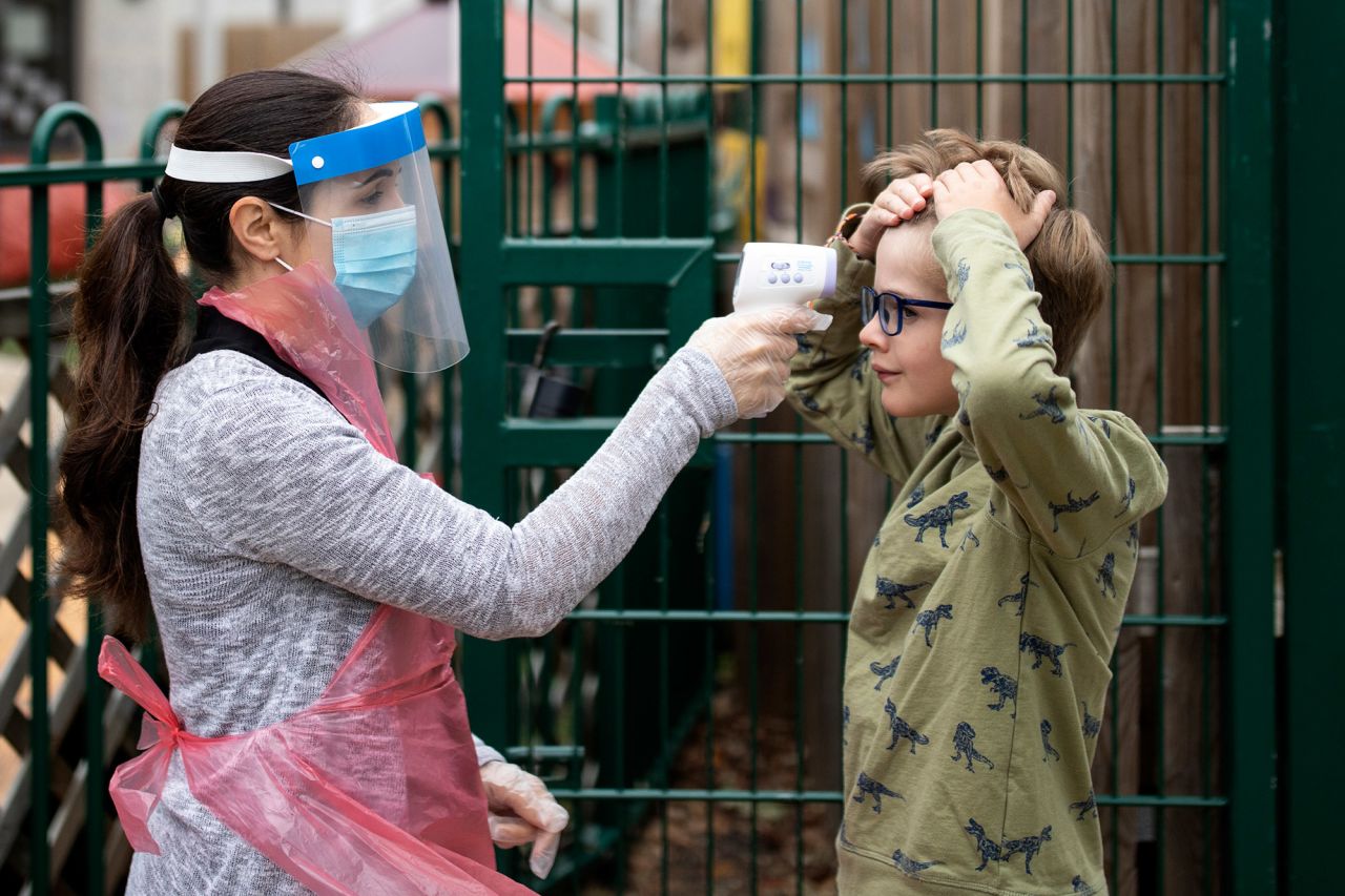 A student's temperature is taken at a school in London on June 4.