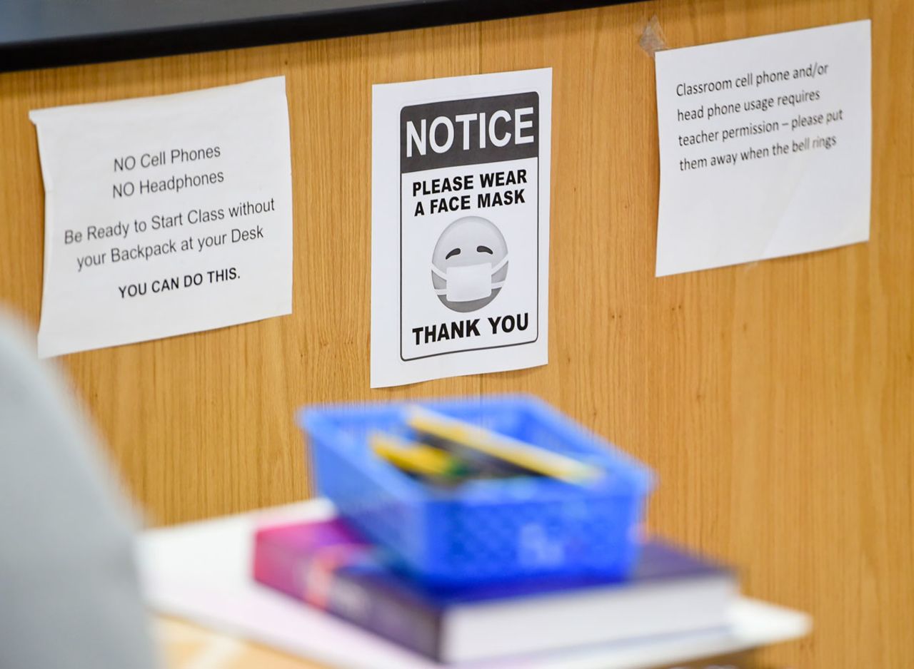 A sign in a classroom reminds students to wear face masks.