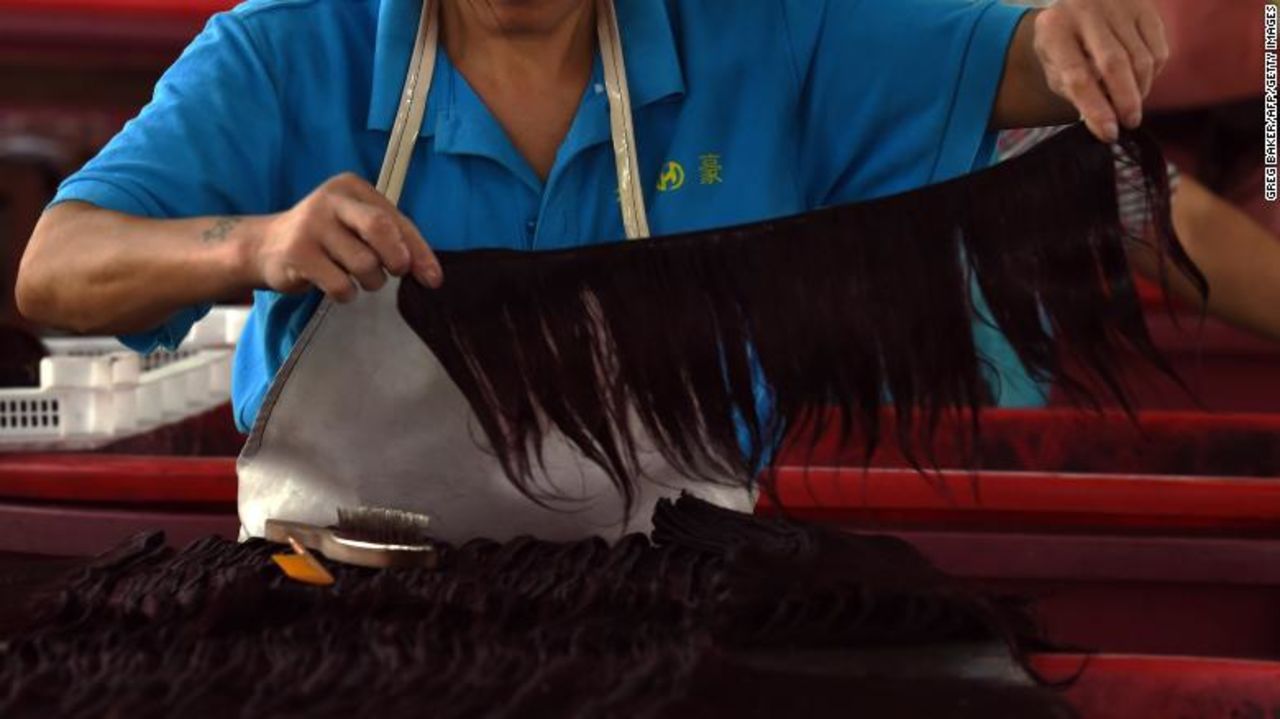 A worker assembles hair extensions at a factory in Taihe, in China's eastern Anhui province.