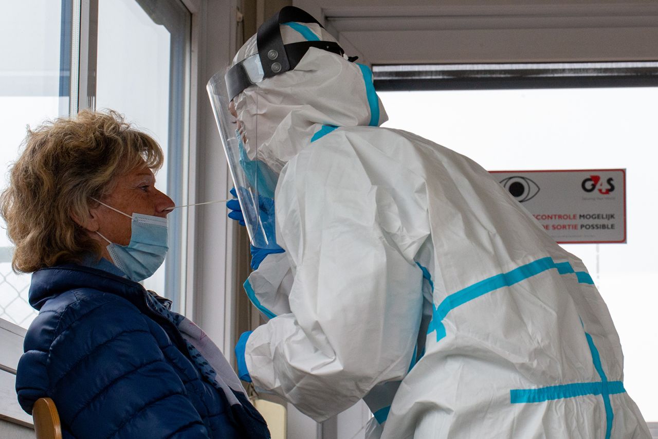 A health worker takes a test sample at a coronavirus testing center in Charleroi, Belgium on October 14.