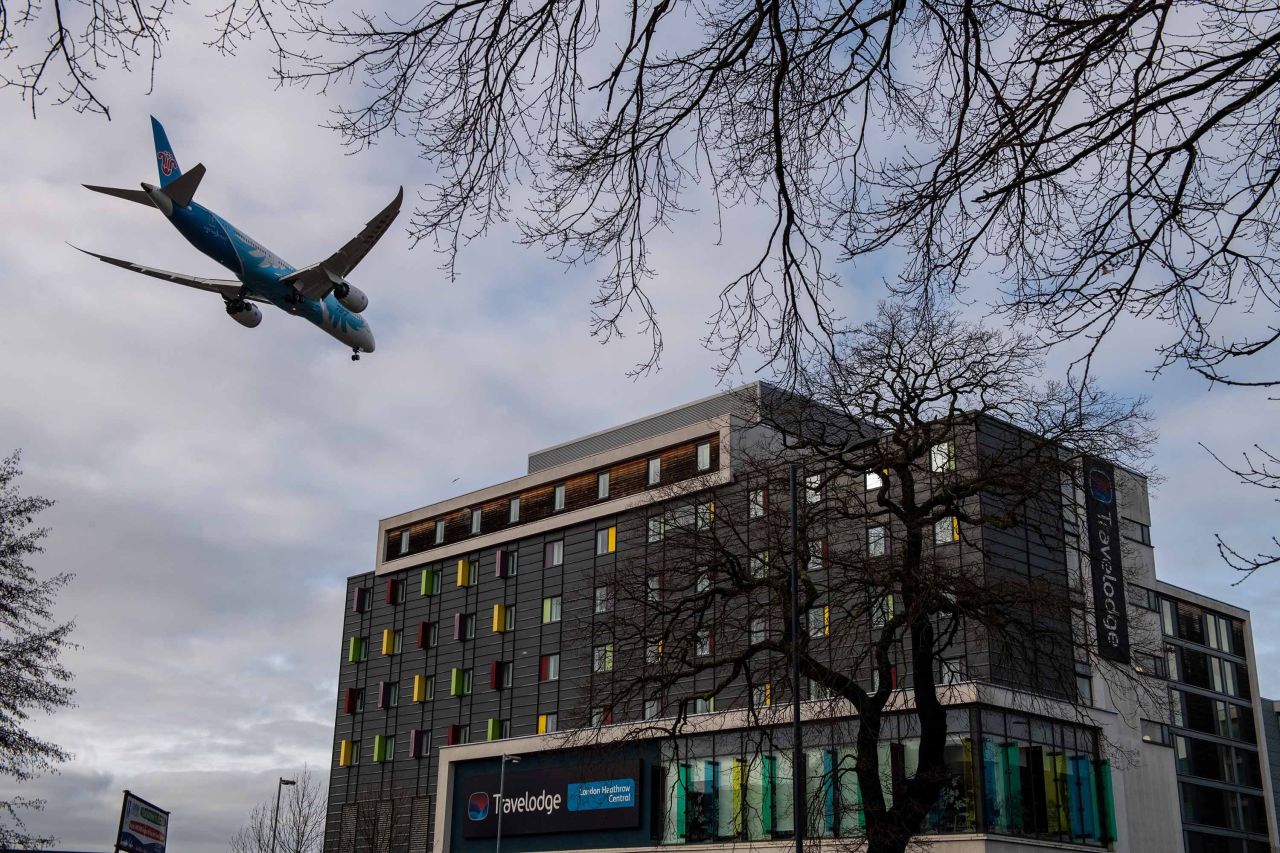 An airplane flies over a Travelodge Hotel as it comes in to land at Heathrow Airport on January 28, in London, England.