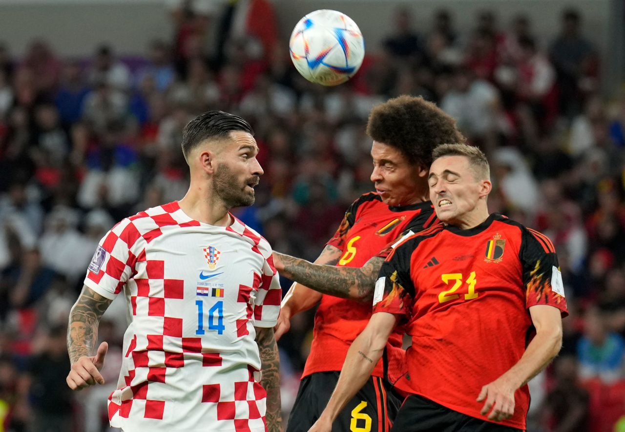 Croatia's Marko Livaja, left, duels for the ball with Belgium's Axel Witsel, center, and Belgium's Timothy Castagne.