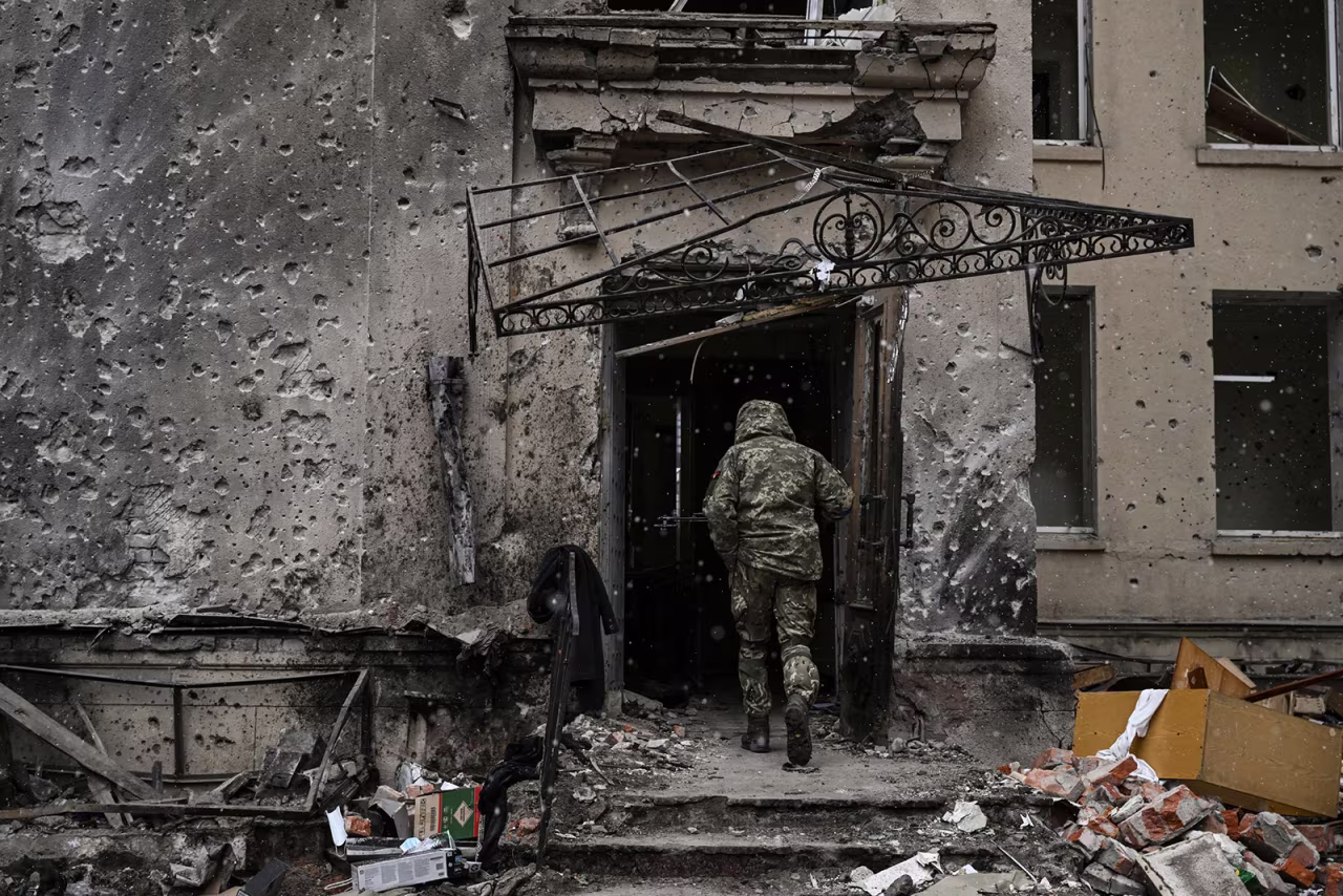 A Ukranian serviceman enters the destroyed regional headquarters of Kharkiv, Ukraine on March 27.