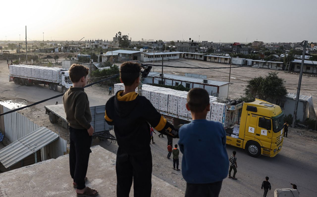 Young boys look at humanitarian aid trucks entering Gaza on November 26. 