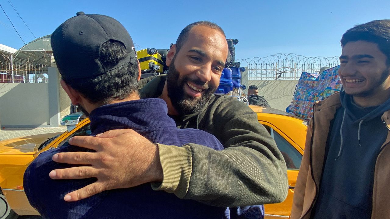 A Palestinian man who was stranded in Egypt due to the Israel-Hamas conflict is welcomed upon his arrival, during a temporary truce, at the Rafah border crossing in southern Gaza on November 24.