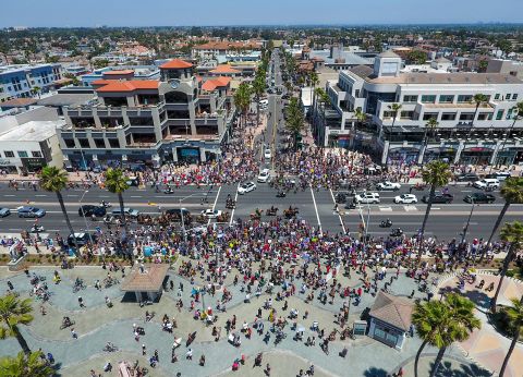Thousands of people gather at the corner of Main Street and Pacific Coast Highway to protest coronavirus (COVID-19) closures in Huntington Beach, California on May 1.
