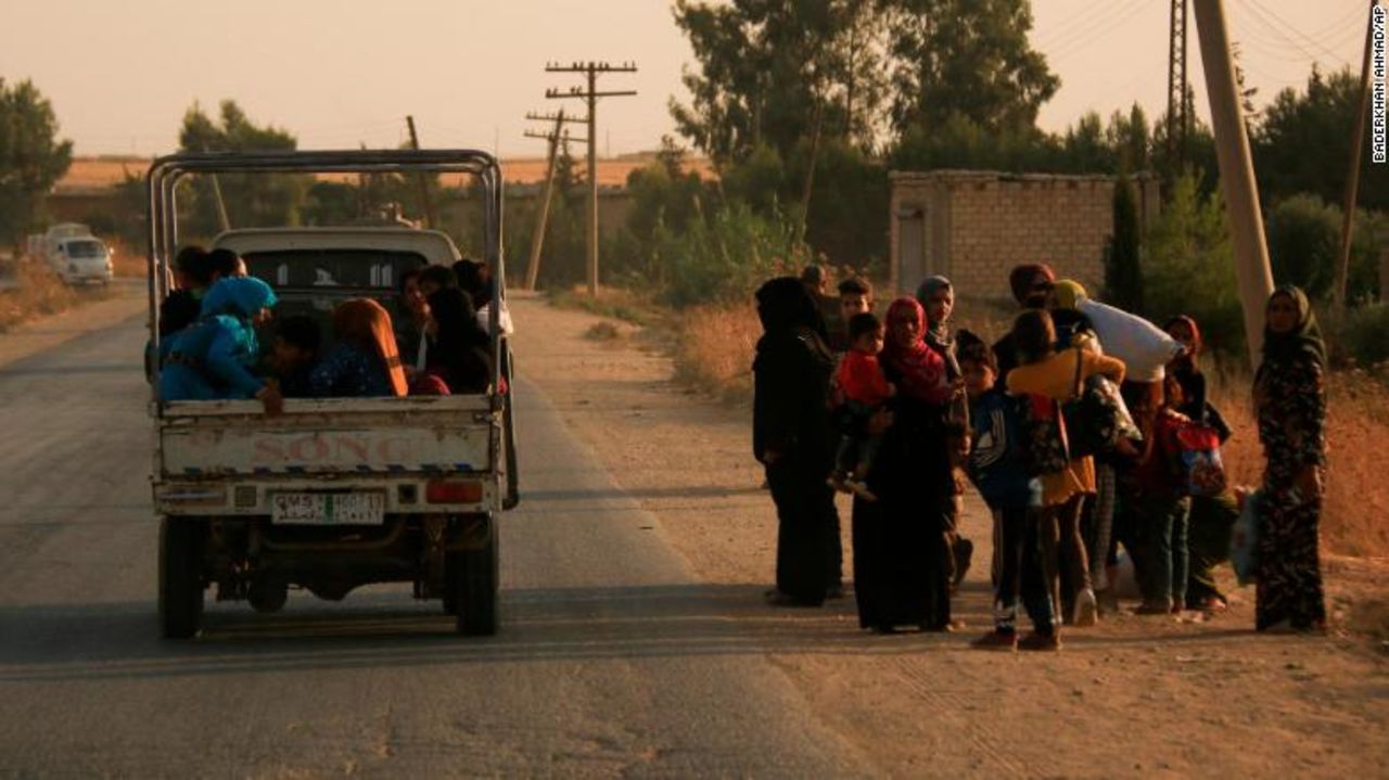 Syrians flee shelling by Turkish forces in Ras al-Ayn, northeast Syria.