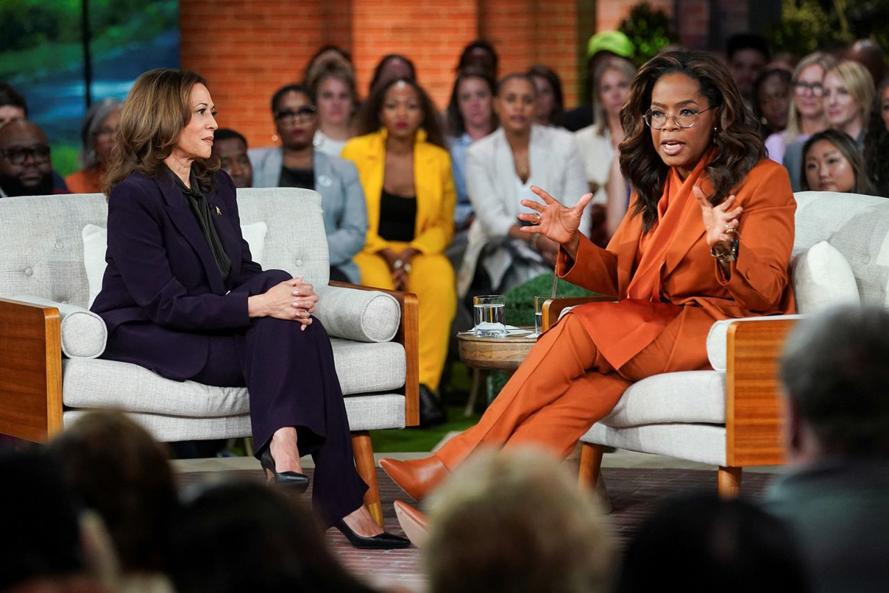 Democratic presidential nominee Vice President Kamala Harris looks on as Oprah Winfrey speaks at a campaign event in Detroit, Michigan, on September 19. 