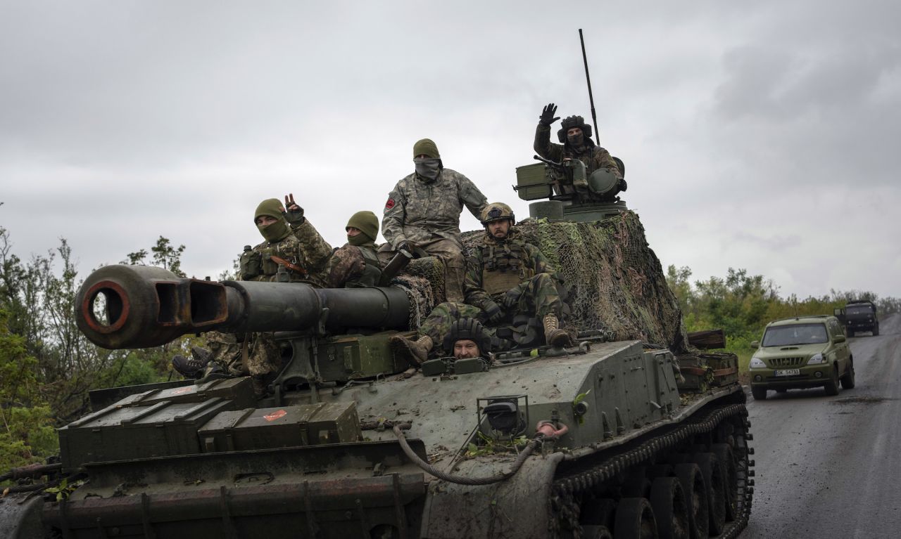 Ukrainian servicemen drive atop a self-propelled artillery vehicle in the recently retaken area of Dolyna, in the Donetsk region on Sept. 14.