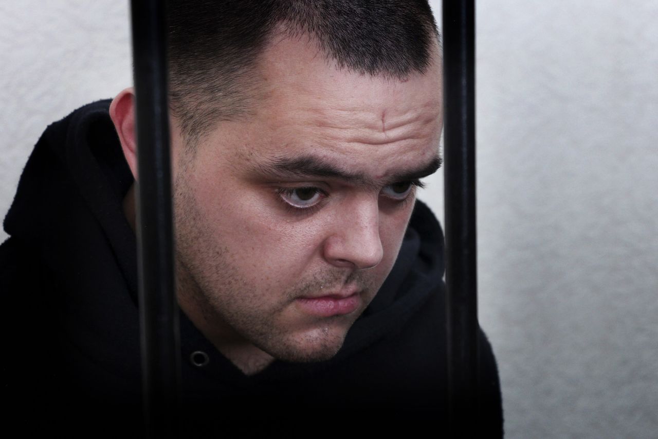 British citizen Aiden Aslin stands behind bars in a courtroom in Donetsk, eastern Ukraine, on June 9.