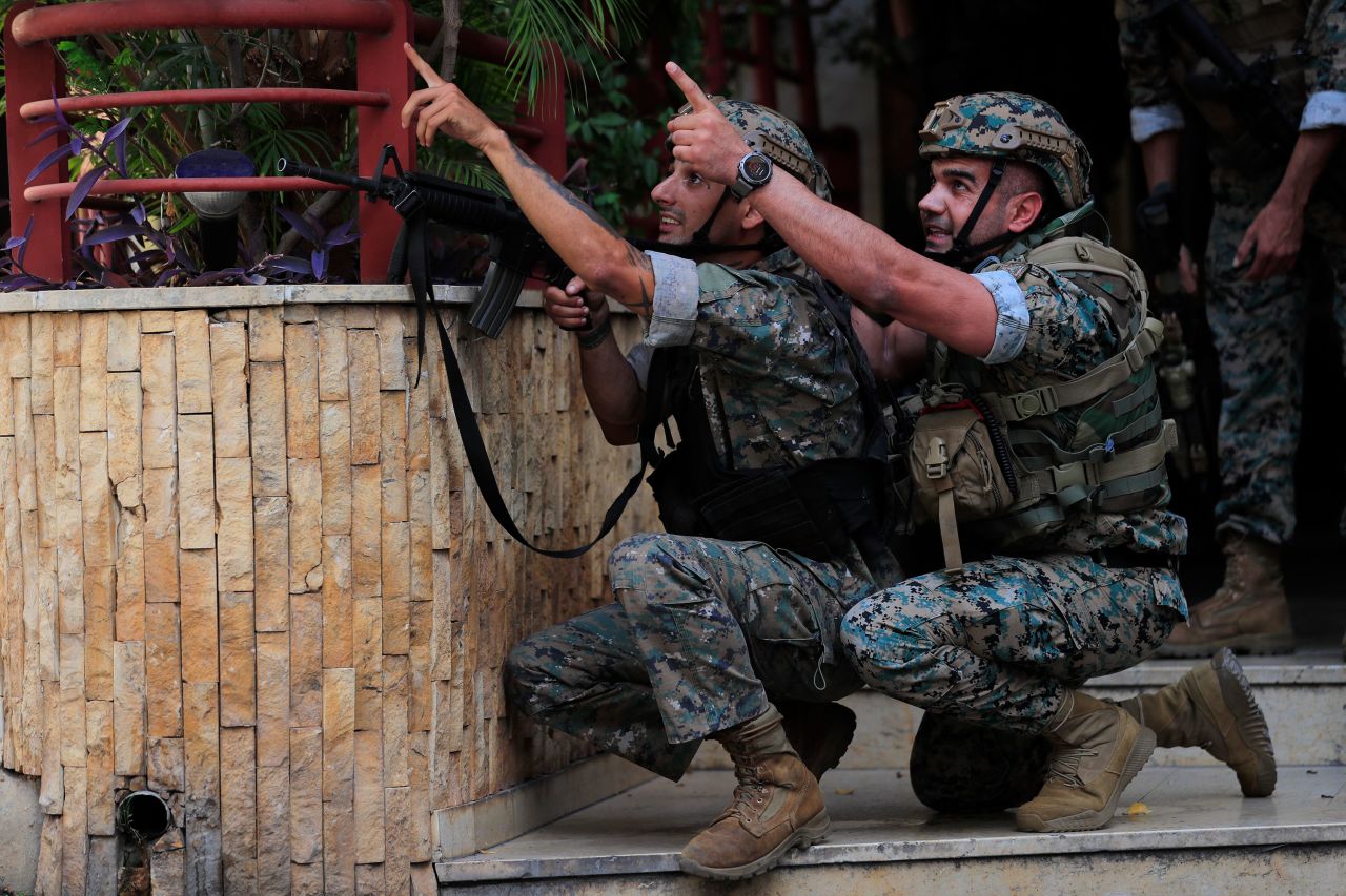 Lebanese security forces react to gunfire during a protest in Beirut on October 14.