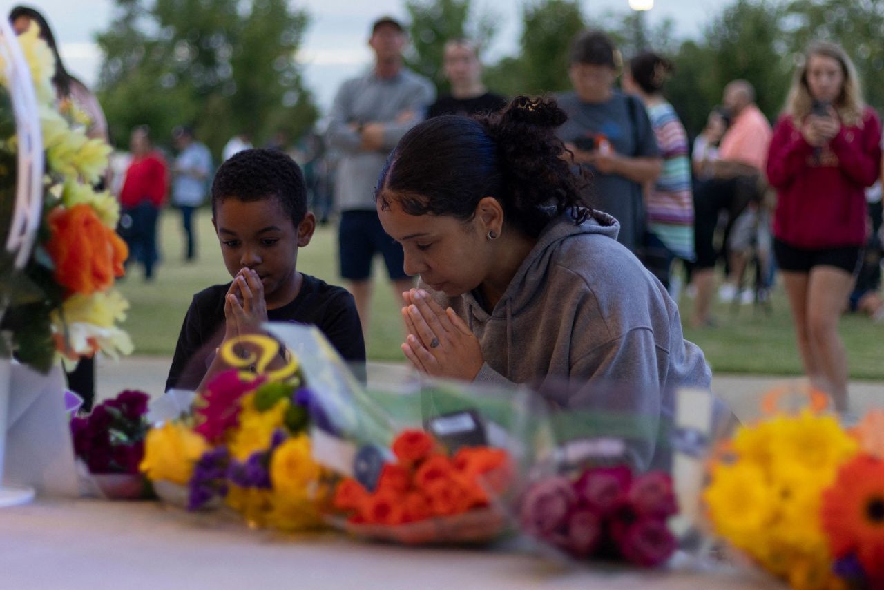 People pray during a vigil on Thursday. 