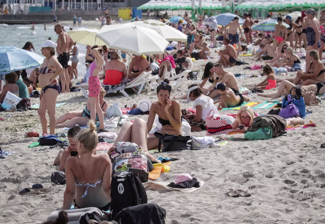 People rest at a Black Sea beach that was reopened after being closed down last year following sea mines laid around the ports of Odesa and Mykolaiv by Russia and Ukraine in Odesa, Ukraine, August 10, 2023.