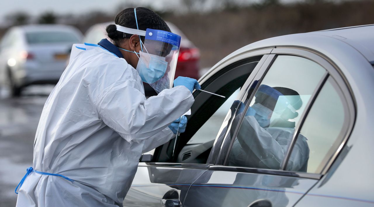 A nurse practitioner administers a Covid-19 swab test in Shirley, New York, on December 18, 2020.