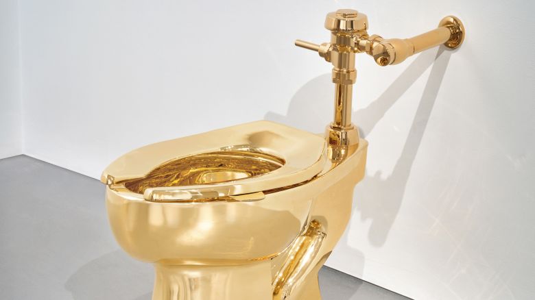 Maurizio Cattelan gold toilet handout from Sotheby's
