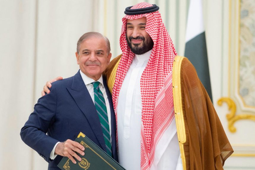 Saudi Crown Prince Mohammed bin Salman and Pakistani Prime Minister Shehbaz Sharif embrace each other after signing a defence agreement, in Riyadh, Saudi Arabia, on Wednesday.