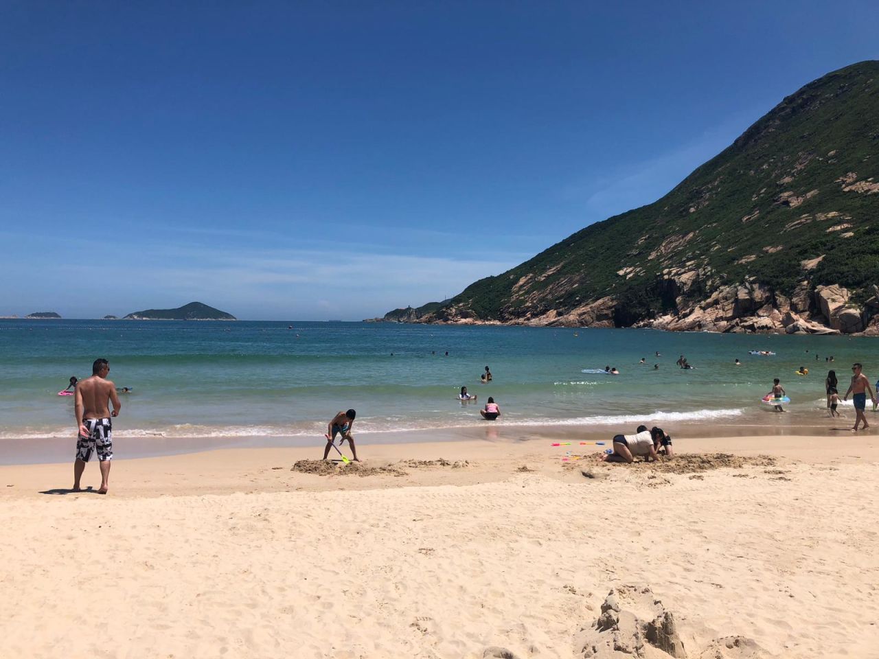 People go for a swim at Hong Kong's Shek O beach, one of the places affected by the lifeguard strike.