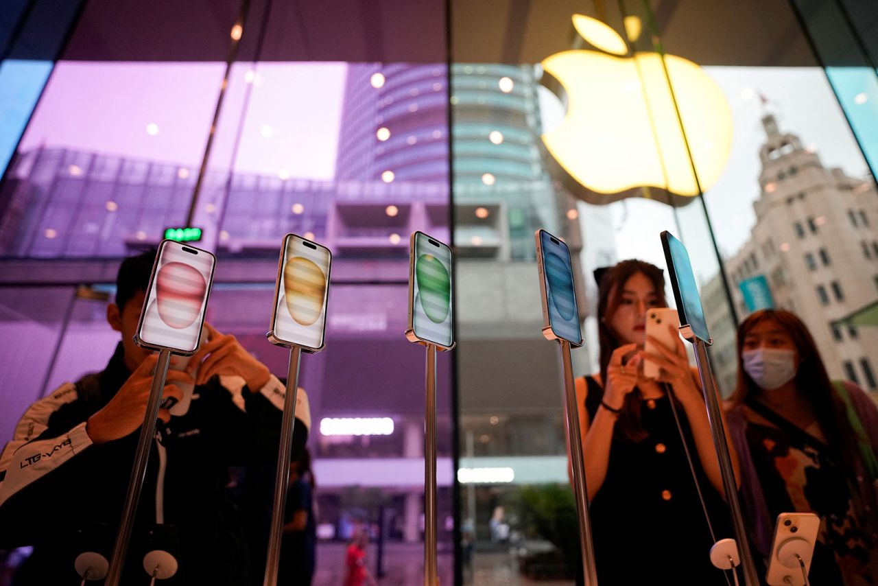 People look at Apple's new iPhone 15 as it officially goes on sale across China, at an Apple store in Shanghai, China, on September 22, 2023.