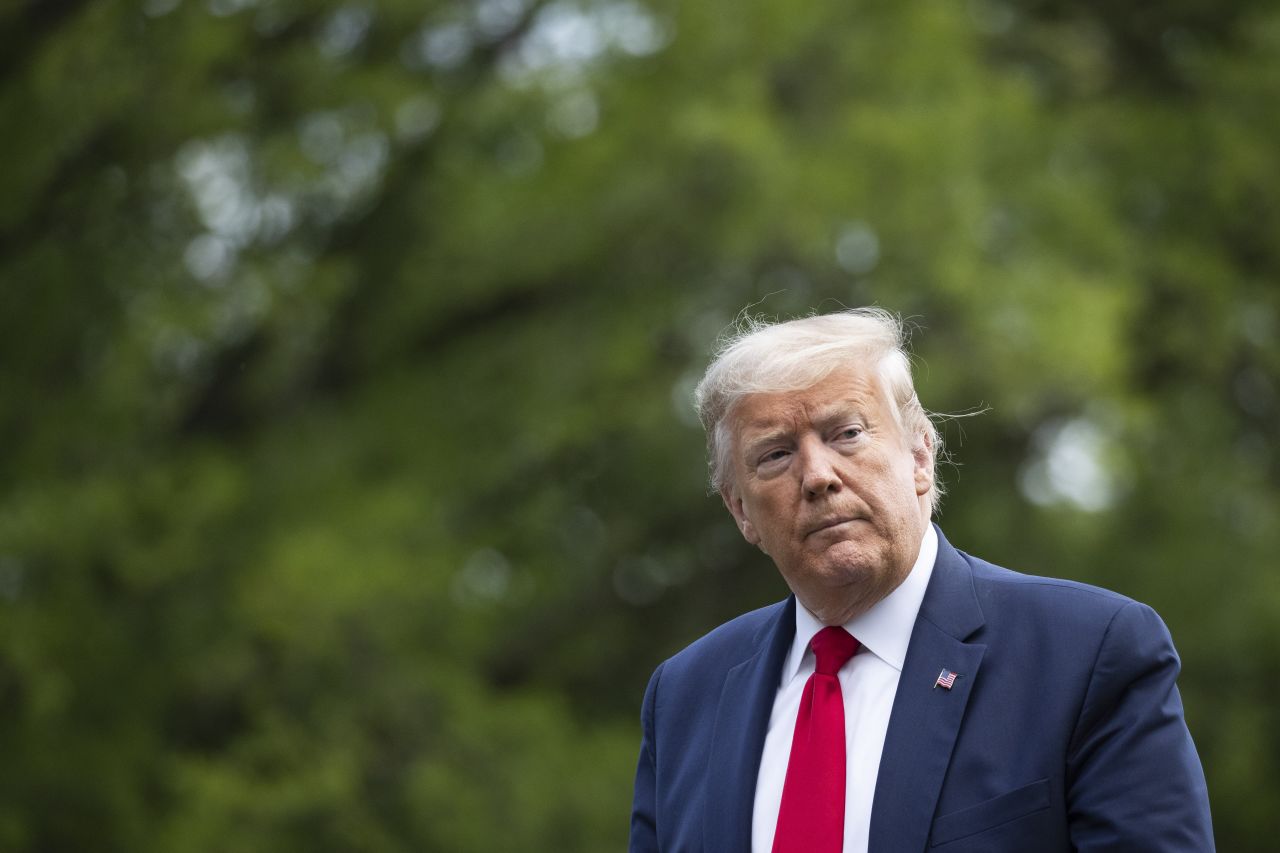 President Donald Trump walks on the South Lawn after returning to the White House on May 14.