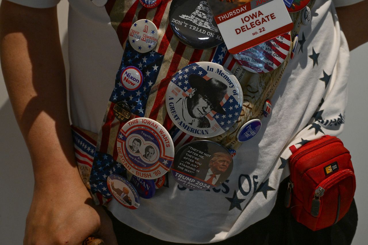 A member of the Iowa delegation wears an assortment of buttons featuring Donald Trump and previous Republican presidents. 