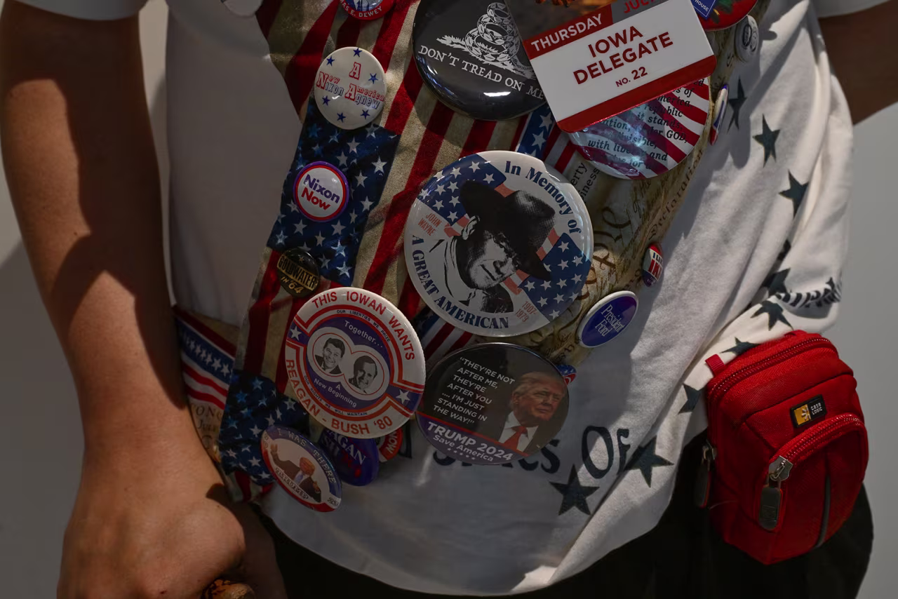 A member of the Iowa delegation wears an assortment of buttons featuring Donald Trump and previous Republican presidents. 
