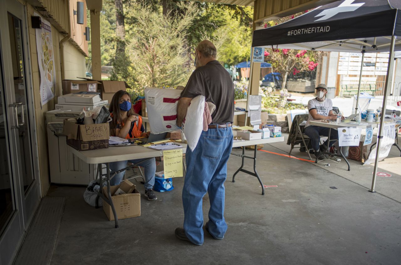 A volunteer checks-in an evacuee at an evacuation center at the Watsonville Fairgrounds in Watsonville, California, on August 26.