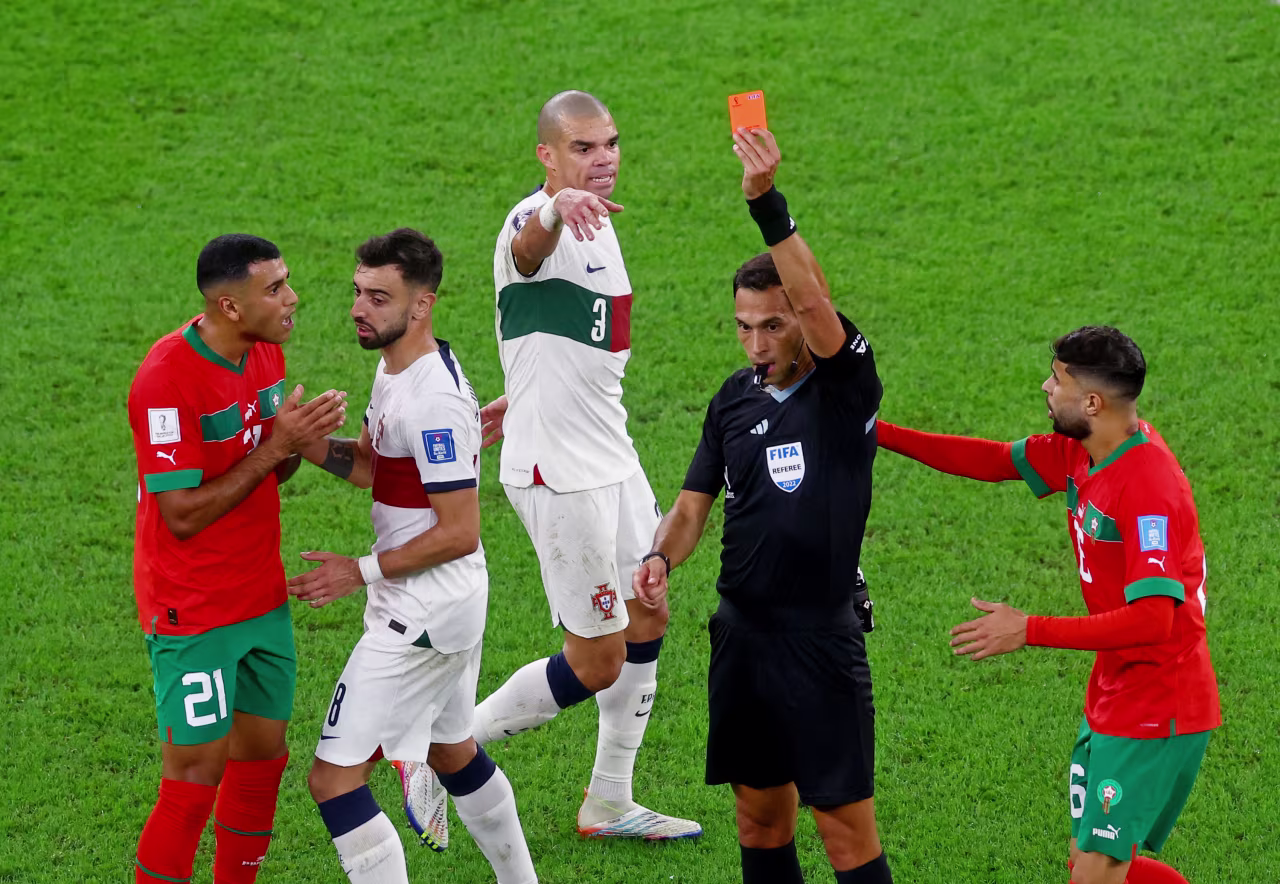 Morocco's Walid Cheddira, far left, is shown a red card by referee Facundo Tello. 