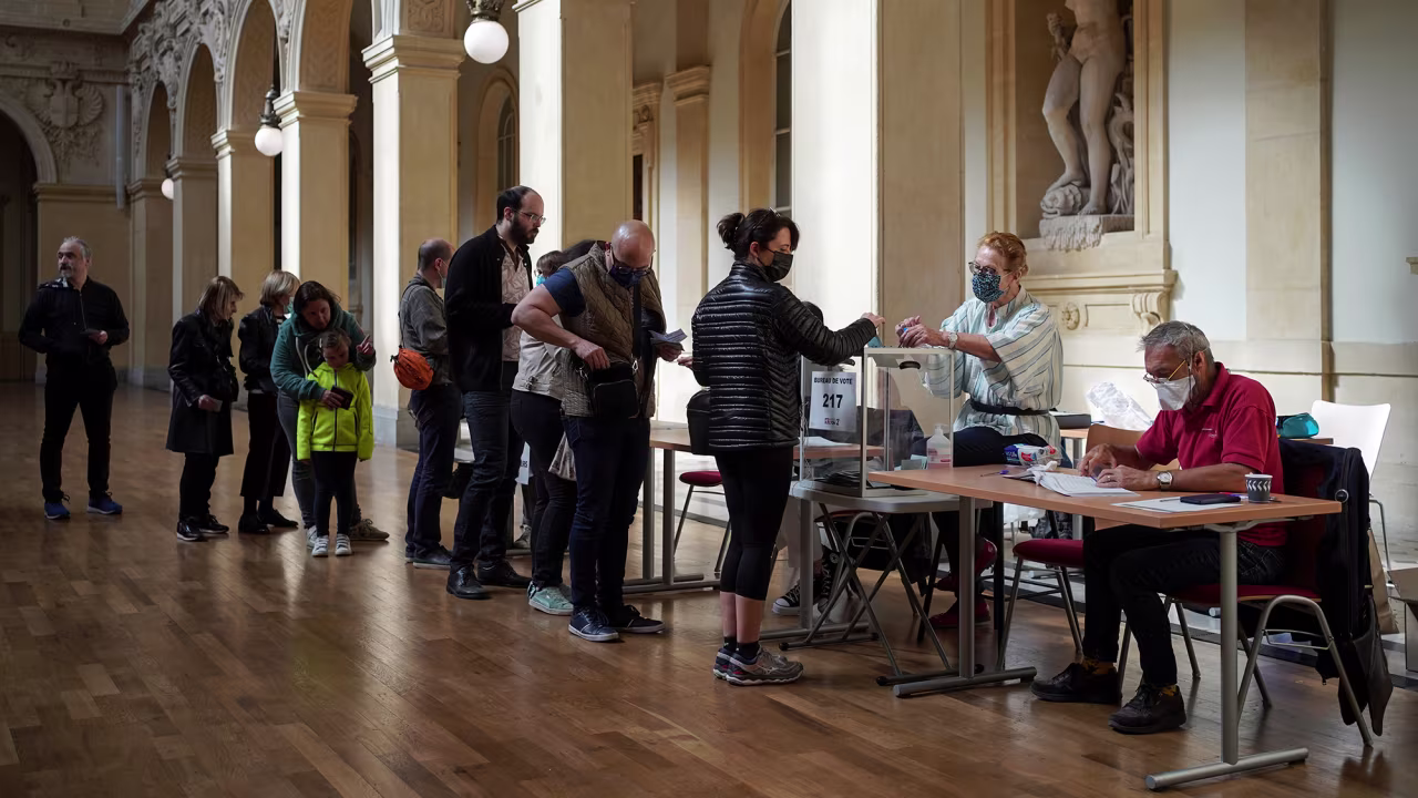 People vote in the second round of the French presidential election in Lyon, France, on Sunday, April 24. 