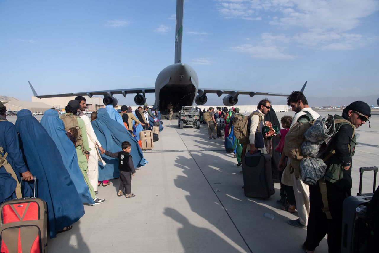 In this handout provided by U.S. Central Command Public Affairs, passengers are seen lining up to board a U.S. Air Force C-17 Globemaster III at Hamid Karzai International Airport on August 24.